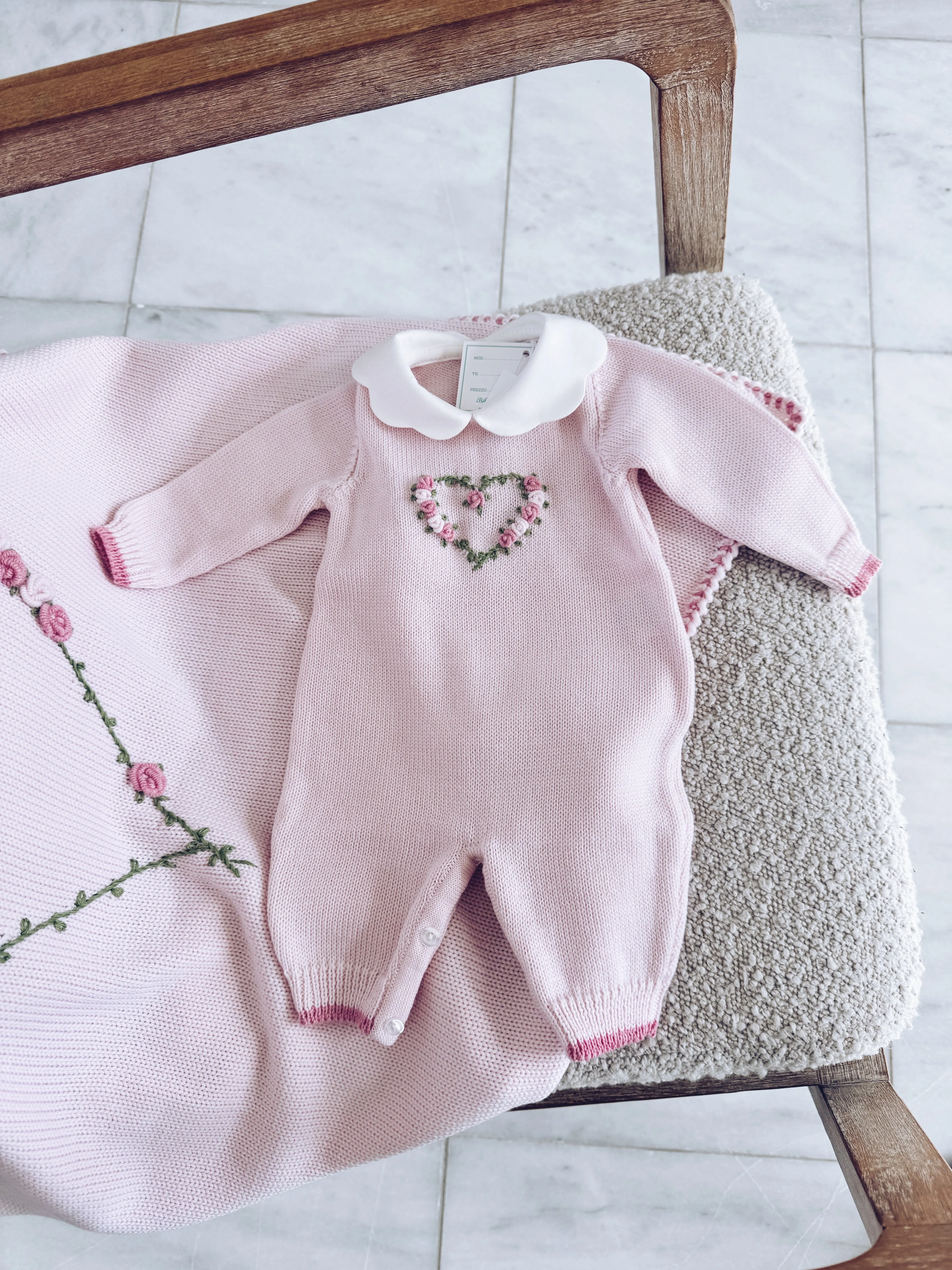 Beautiful Knitted Merino Wool Baby Girl Romper with hand embroidery floral details.