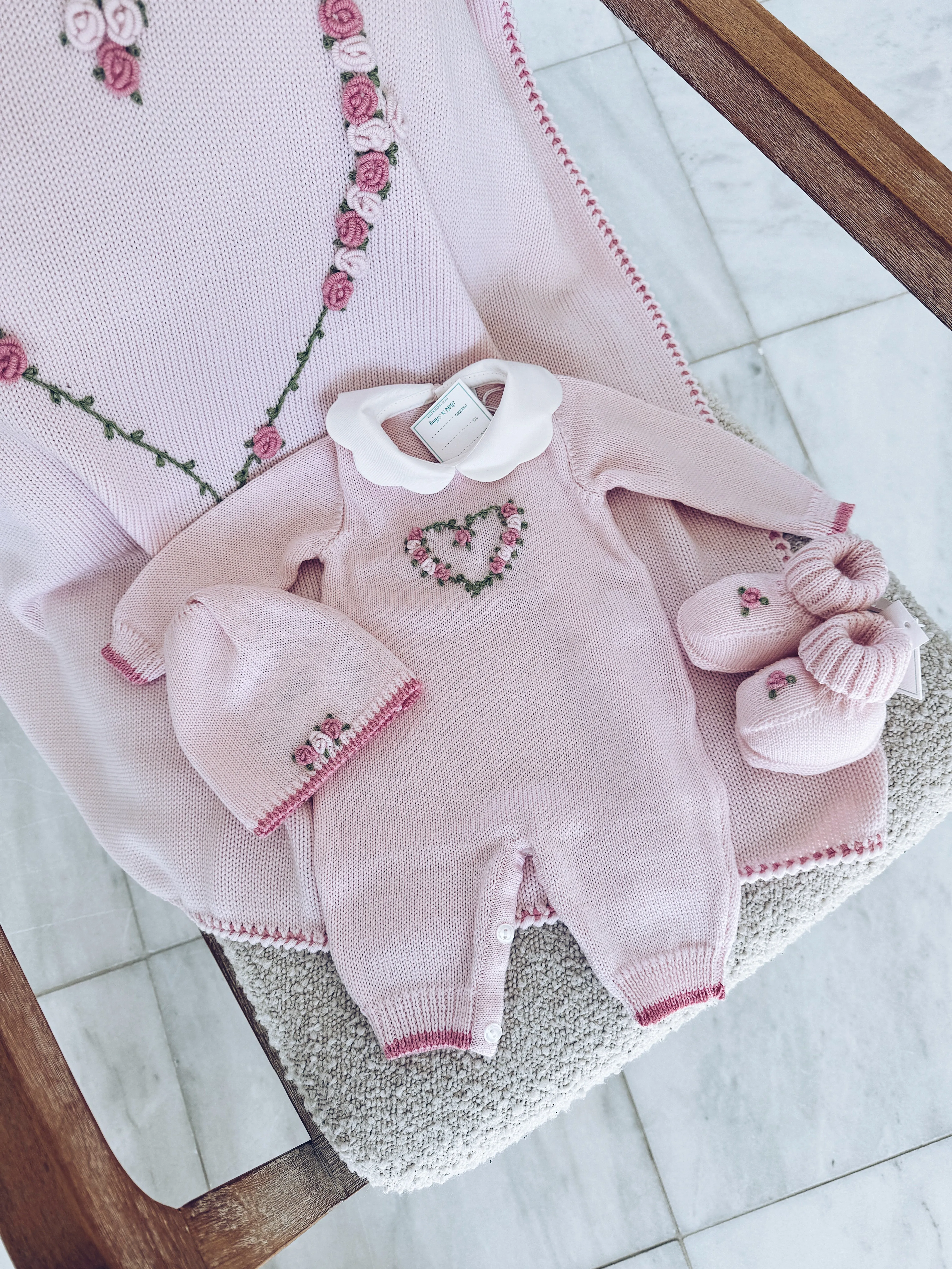 Beautiful Knitted Merino Wool Baby Girl Romper with hand embroidery floral details.